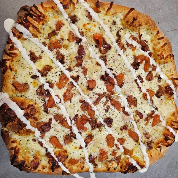 Patsy's Bar & Grill's square pizza with melted cheese, bacon, and a ranch drizzle.