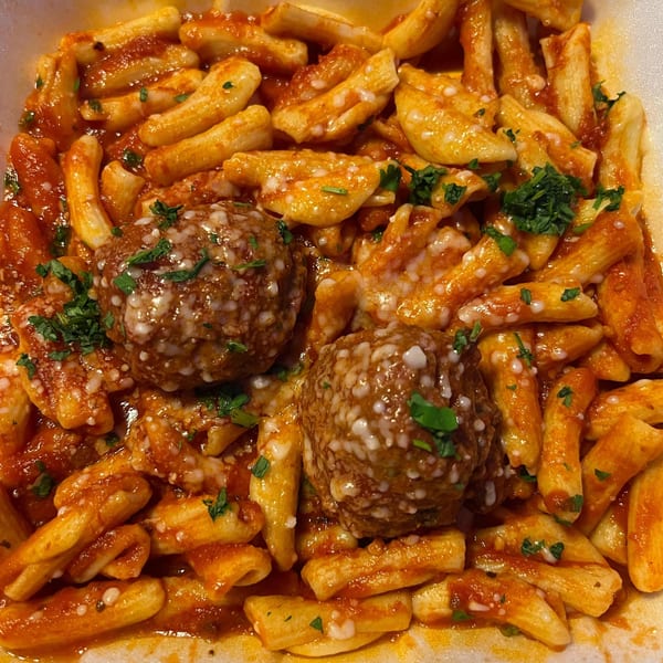 Patsy's Bar & Grill's penne pasta with marinara sauce, two meatballs, and fresh parsley.